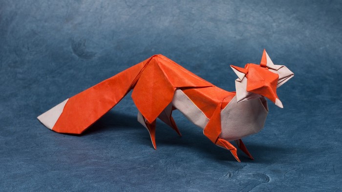 Origami fox on a blue textured background