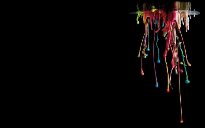 Colorful paint dripping from a surface