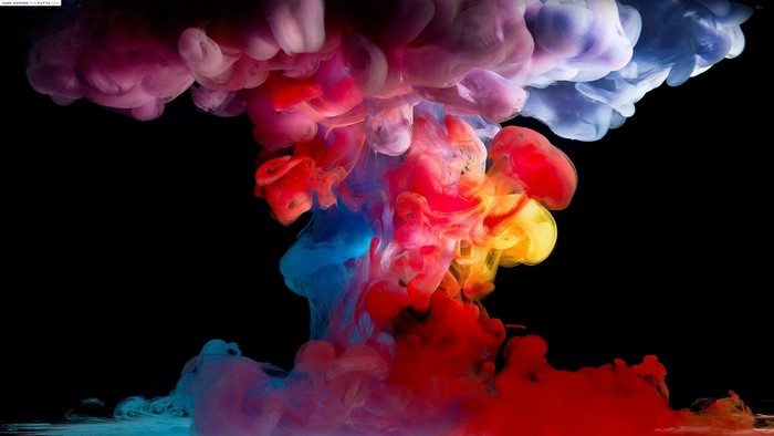 Colorful paint in water on black background