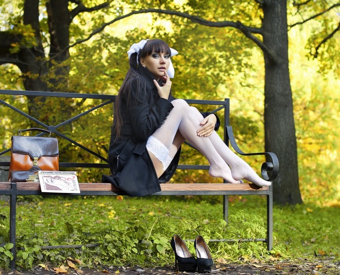 Model in White Stockings Sitting on Park Bench