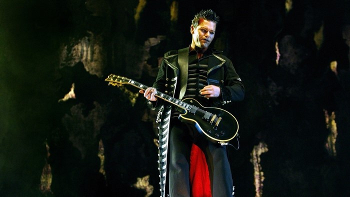 Richard Kruspe of Rammstein playing guitar on stage