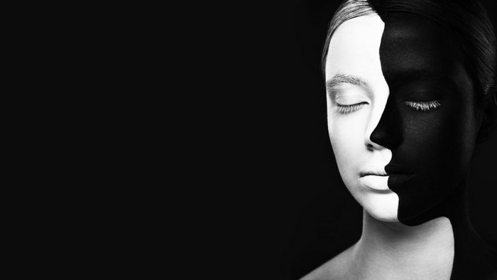 Monochrome portrait of a woman with black and white face paint