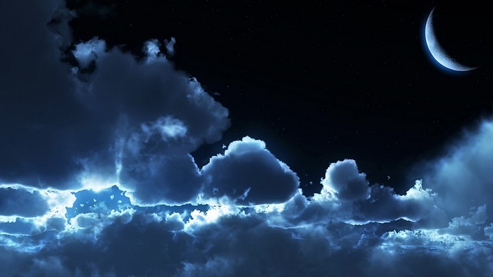 Crescent moon in a cloudy night sky