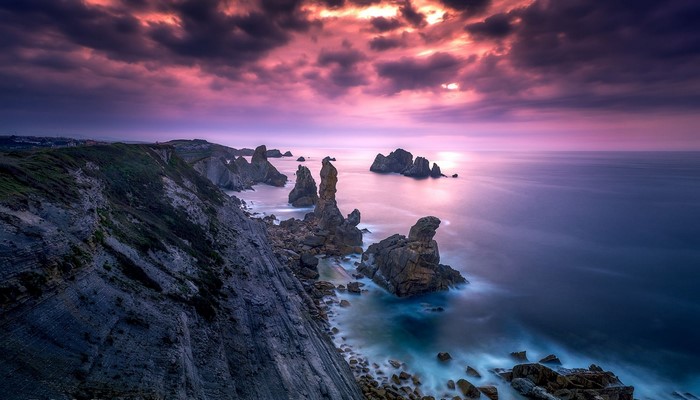 Rocky coast with sea stacks at sunset in Spain