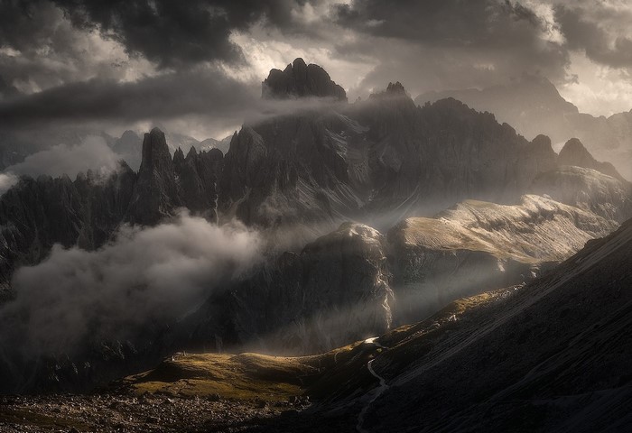 Dramatic mountain landscape with sun rays and clouds