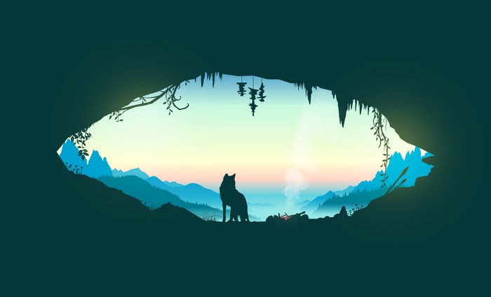 Wolf sitting in a cave looking at a mountain landscape