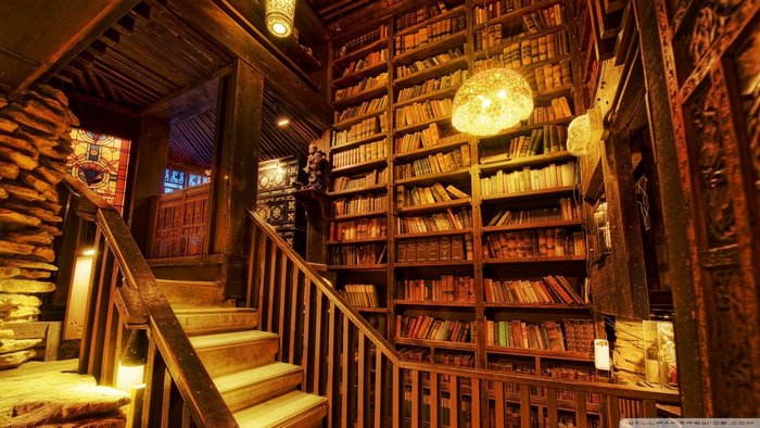 Interior of a library with bookshelves and a staircase