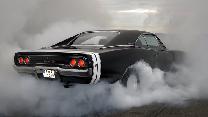 Black Dodge Charger performing a burnout