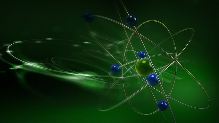 Atom model with orbiting electrons on green background