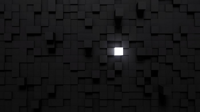 Black cubes with one glowing white cube