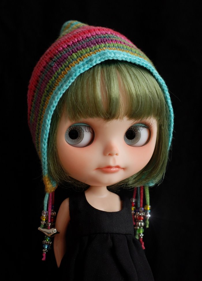 Doll wearing a colorful knitted hat