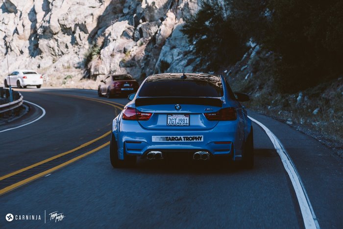 Blue BMW M4 Coupe on a Mountain Road