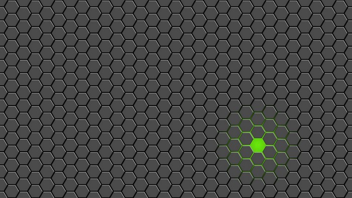 Green glowing hexagons on a dark tiled surface