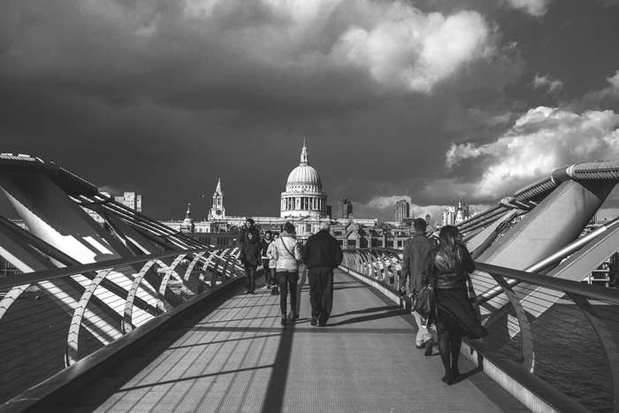 People walking on Millennium Bridge towards St. Paul's Cathedral, London