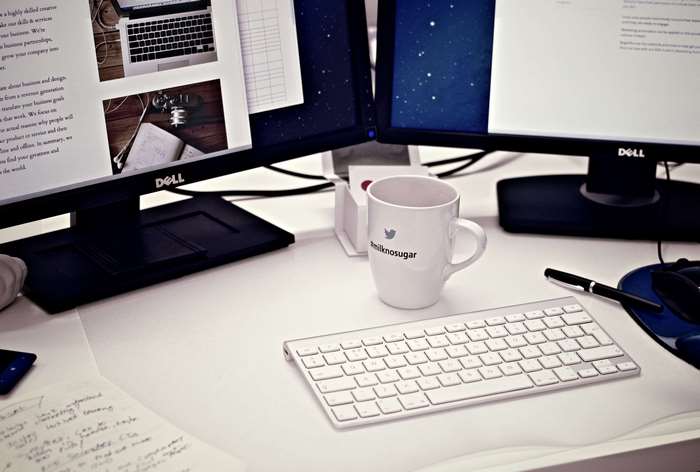 Dell monitors, keyboard, and mug on a desk