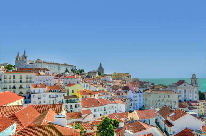 Lisbon cityscape with colorful houses and the sea