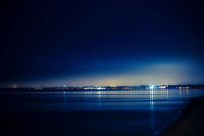 Night view of Sopot city lights reflecting on the sea