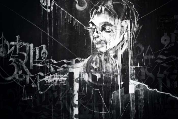 Graffiti art of a face on a black wall