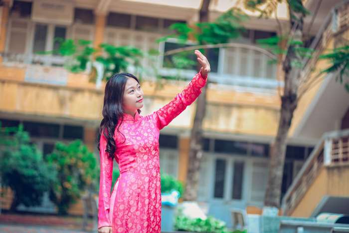 Young woman in pink dress posing outdoors