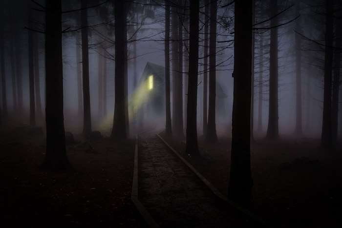 Mysterious Haunted House in Foggy Forest at Night