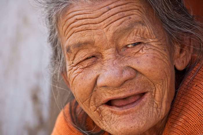 Elderly woman with deep wrinkles smiling