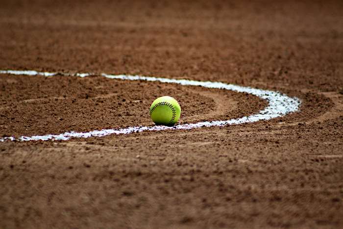 Softball on a baseball field with white chalk line