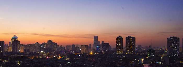 Hanoi cityscape at sunset with illuminated buildings