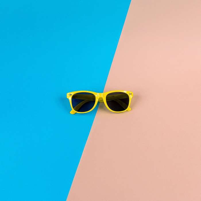 Yellow Wayfarer Sunglasses on Pastel Background
