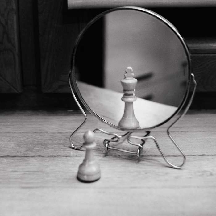 Pawn reflecting as a king in a mirror