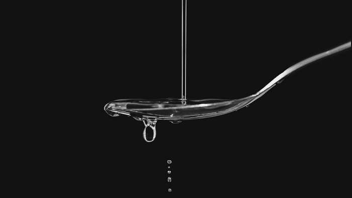 Water drops falling from a spoon