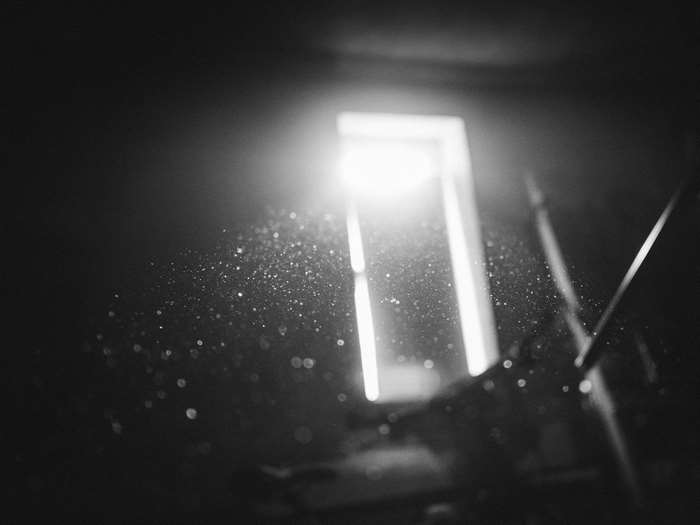 Dust particles illuminated by sunlight through a window
