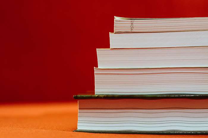 Stack of books on red background 4K