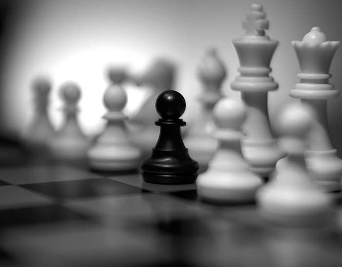Black pawn against white chess pieces 4K