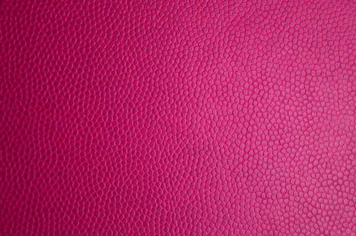 Bright pink textured leather material surface