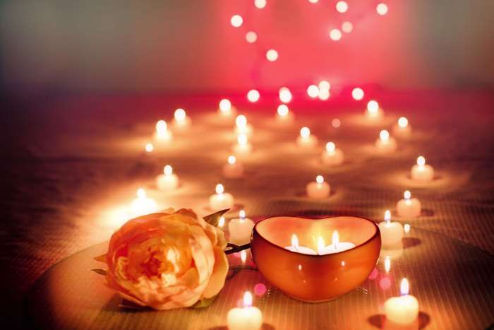 Romantic candlelight with rose and heart-shaped candle