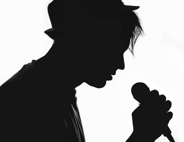 Silhouette of a musician with a microphone