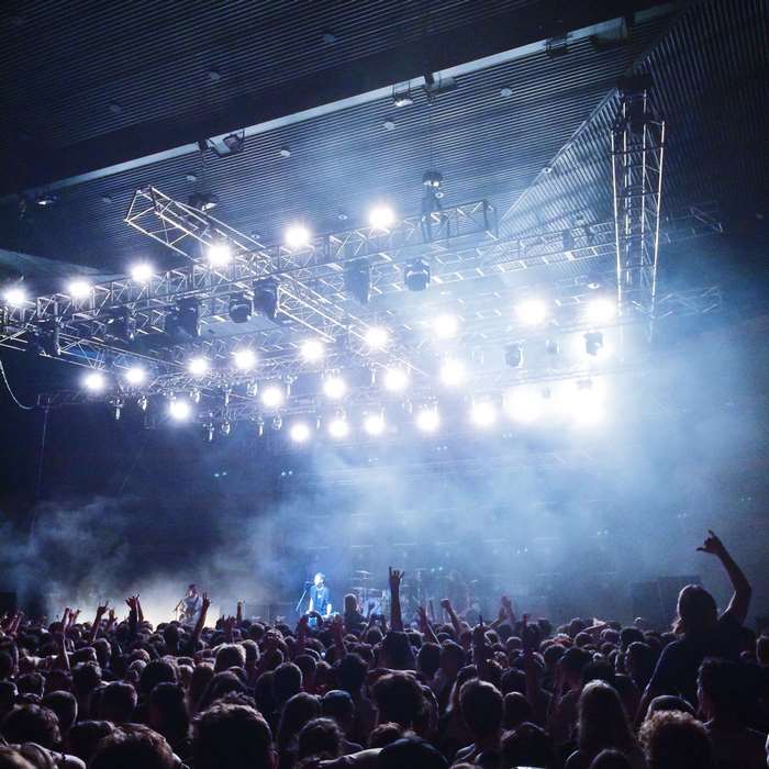 Concert crowd with stage lights and performers