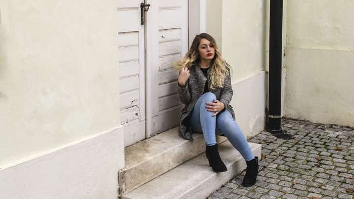 Woman with blonde hair sitting on steps