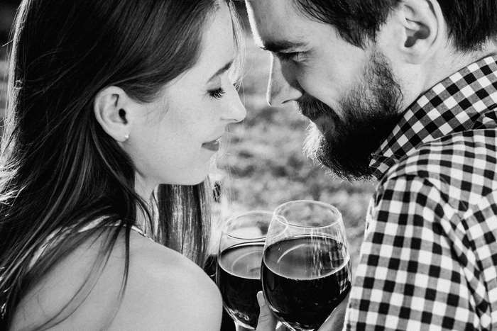Couple sharing wine and looking at each other
