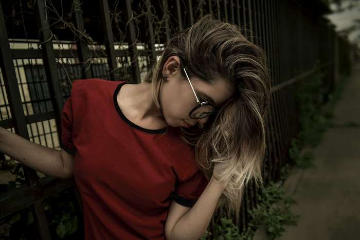 Young woman with glasses and red shirt