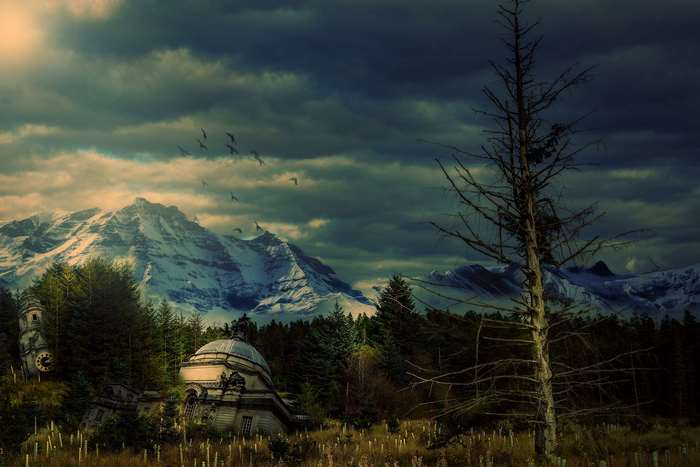 Apocalyptic landscape with abandoned buildings and snowy mountains