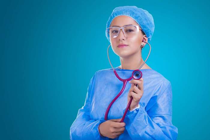 Young female doctor in surgical attire with stethoscope