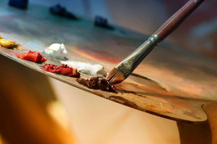 Artist's palette with oil paints and brush 4K