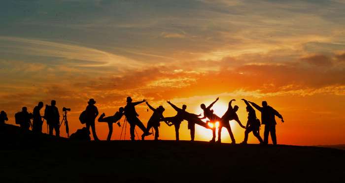 Group of people posing at sunset