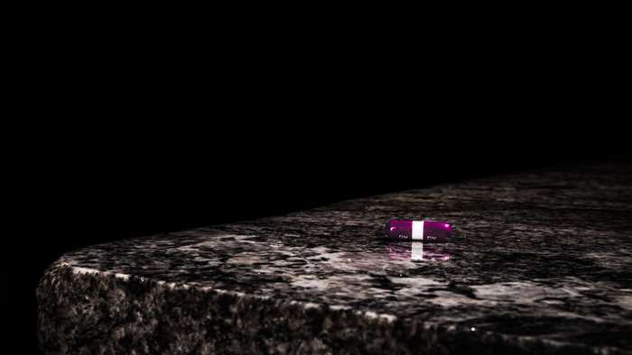 Purple capsule on a marble table