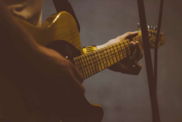 Person playing an electric guitar