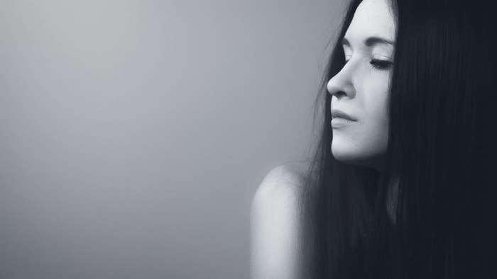Woman with long dark hair in profile