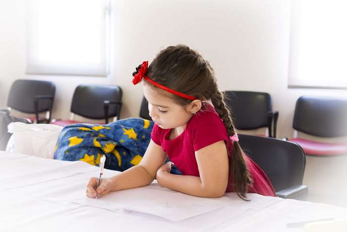 Young girl writing at a table