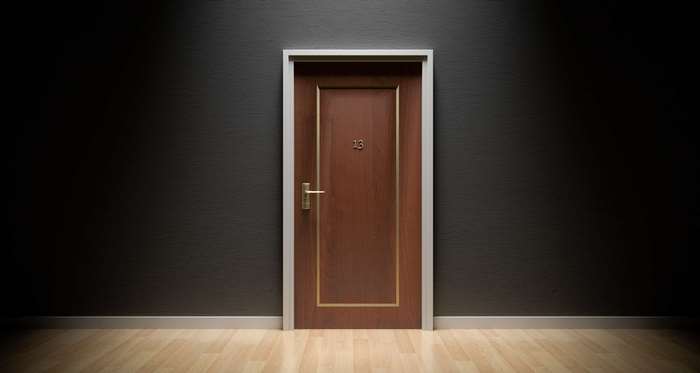 Door number 13 in a dark hallway