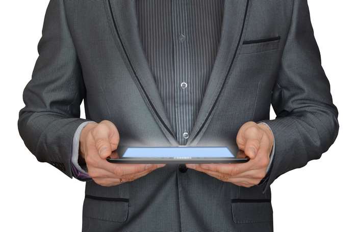 Businessman holding a glowing tablet computer